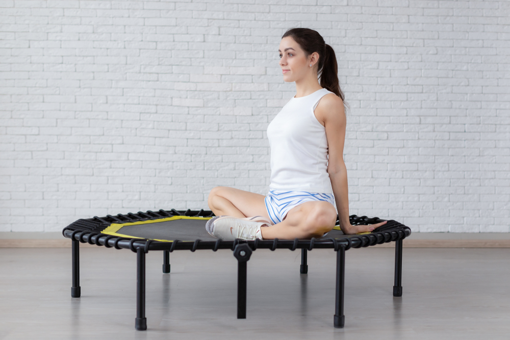 Relaxed,Woman,Sitting,On,Trampoline.girl,Doing,Yoga,On,Trampolines